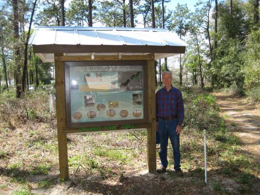 a photo of Tom Walker next to a kiosk