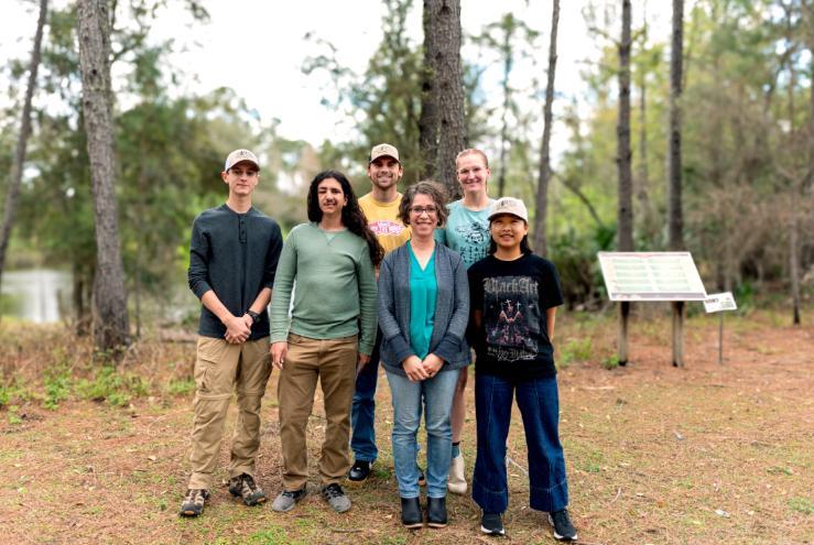 operation committee members standing in front of a pond