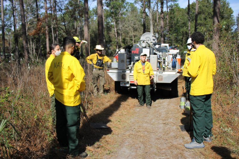 the NATL burn boss briefing his team before a burn